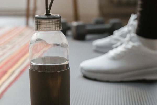 Detail shot of a yoga mat and a water bottle.